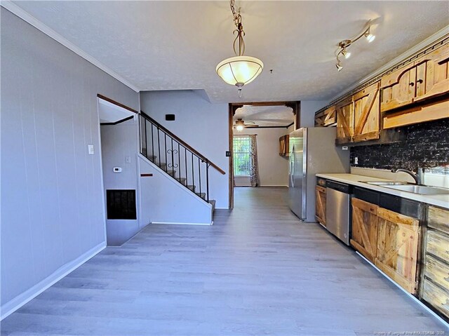 6261 Stoney Point Loop, Fayetteville, NC 28306 - kitchen with stainless steel appliances, light wood-style flooring, ceiling fan, backsplash, and crown molding