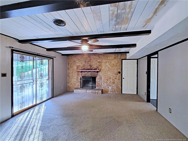 6261 Stoney Point Loop, Fayetteville, NC 28306 - unfurnished living room featuring ceiling fan, carpet flooring, beamed ceiling, a stone fireplace, and wooden ceiling