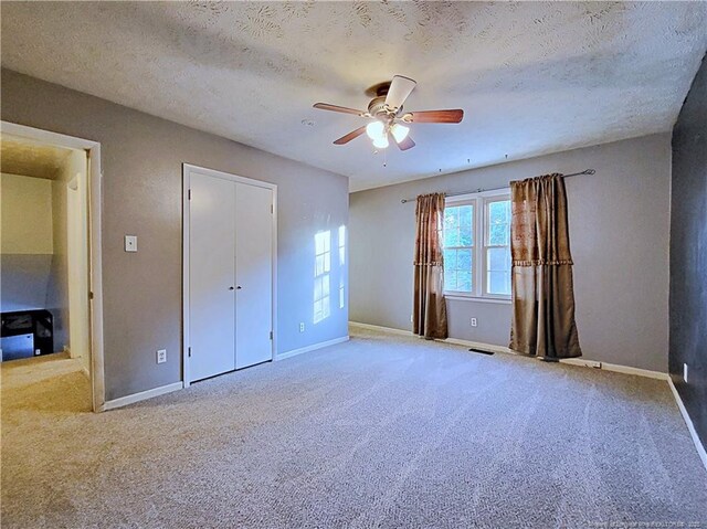 6261 Stoney Point Loop, Fayetteville, NC 28306 - unfurnished bedroom featuring carpet, baseboards, a textured ceiling, and a ceiling fan