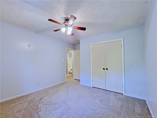 6261 Stoney Point Loop, Fayetteville, NC 28306 - unfurnished bedroom featuring carpet, baseboards, a ceiling fan, and a closet