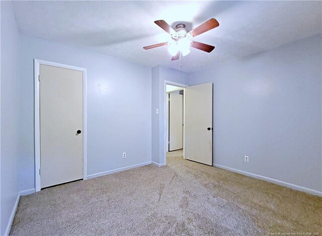 6261 Stoney Point Loop, Fayetteville, NC 28306 - unfurnished bedroom featuring light colored carpet, baseboards, and ceiling fan