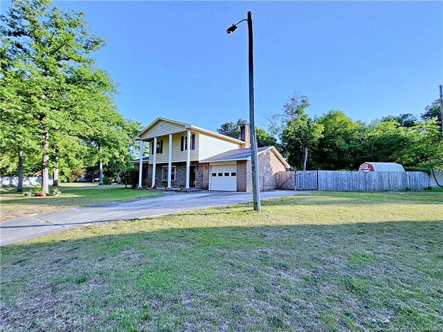 6261 Stoney Point Loop, Fayetteville, NC 28306 - view of front of house featuring driveway, a gate, and an attached garage