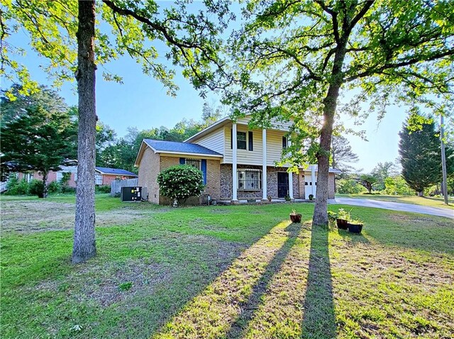 6261 Stoney Point Loop, Fayetteville, NC 28306 - view of front of home featuring driveway, brick siding, a front yard, and an attached garage