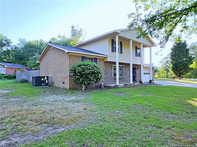 6261 Stoney Point Loop, Fayetteville, NC 28306 - view of front of home featuring a garage, brick siding, driveway, central AC, and crawl space