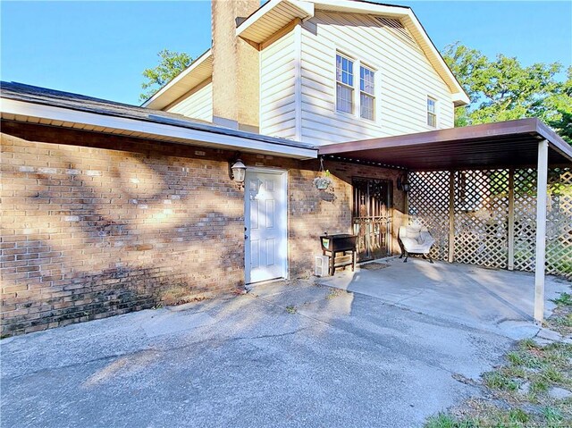 6261 Stoney Point Loop, Fayetteville, NC 28306 - exterior space with a chimney, brick siding, and a patio