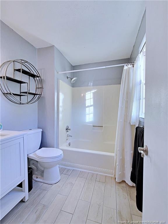 6261 Stoney Point Loop, Fayetteville, NC 28306 - full bath featuring wood finished floors, shower / tub combo with curtain, toilet, and vanity