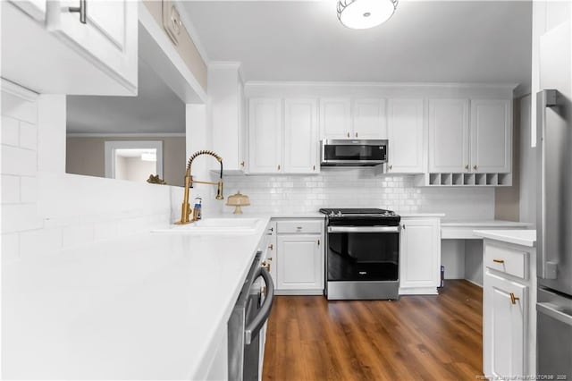 1001 N Orange Ave, Dunn, NC 28334 - kitchen with appliances with stainless steel finishes, a sink, light countertops, tasteful backsplash, and ornamental molding