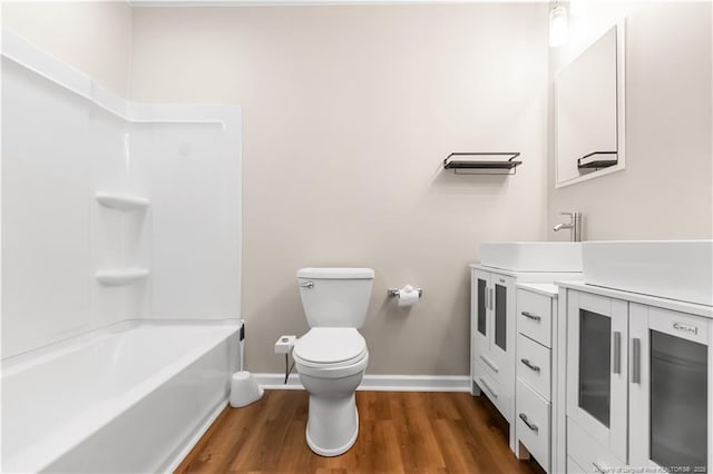 1001 N Orange Ave, Dunn, NC 28334 - bathroom with baseboards, wood finished floors, toilet, and vanity