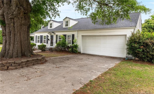 1001 N Orange Ave, Dunn, NC 28334 - new england style home featuring driveway, a garage, and a shingled roof