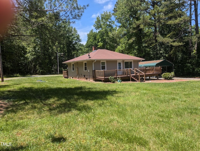 rear view of house with a deck, a lawn, and a chimney