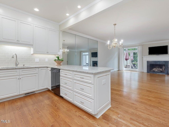 3347 Ridgecrest Ct, Raleigh, NC 27607 - kitchen with a fireplace, open floor plan, black dishwasher, a chandelier, and crown molding