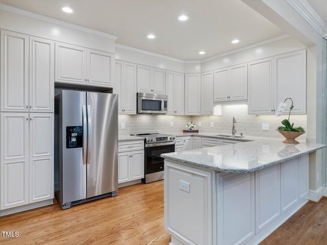 3347 Ridgecrest Ct, Raleigh, NC 27607 - kitchen with appliances with stainless steel finishes, a sink, a peninsula, white cabinets, and light stone counters
