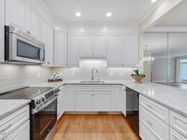 3347 Ridgecrest Ct, Raleigh, NC 27607 - kitchen with stainless steel appliances, a sink, light wood-style floors, white cabinetry, and crown molding