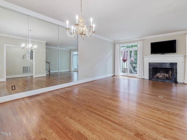 3347 Ridgecrest Ct, Raleigh, NC 27607 - unfurnished living room with a chandelier, a fireplace, wood finished floors, ornamental molding, and baseboards