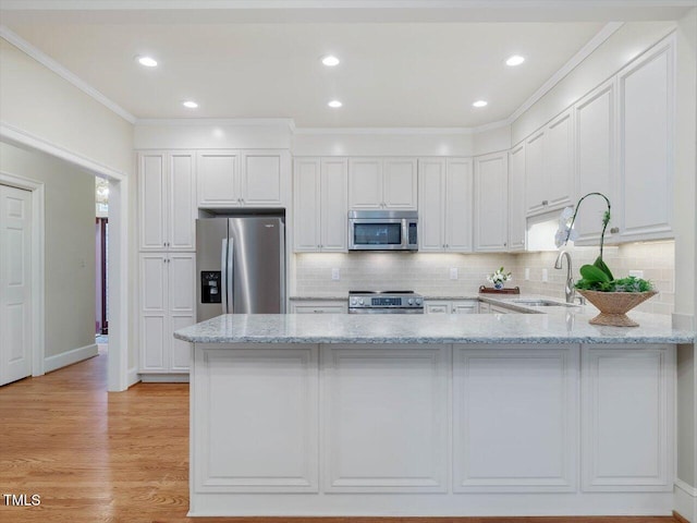 3347 Ridgecrest Ct, Raleigh, NC 27607 - kitchen with stainless steel appliances, a peninsula, light stone countertops, decorative backsplash, and white cabinetry