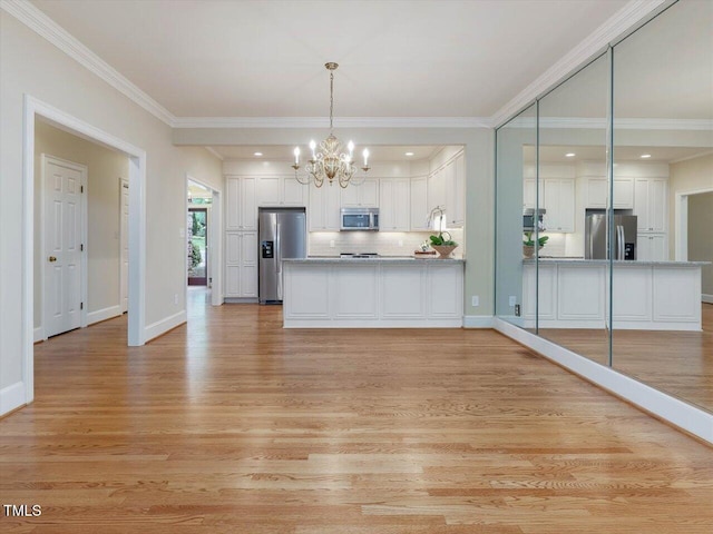 3347 Ridgecrest Ct, Raleigh, NC 27607 - kitchen with appliances with stainless steel finishes, a peninsula, white cabinets, light wood-style floors, and crown molding