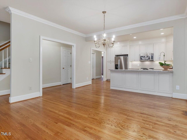 3347 Ridgecrest Ct, Raleigh, NC 27607 - kitchen featuring stainless steel appliances, a chandelier, light wood finished floors, a peninsula, and white cabinets
