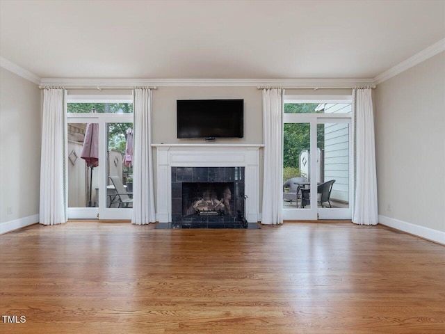 3347 Ridgecrest Ct, Raleigh, NC 27607 - unfurnished living room with crown molding, wood finished floors, a tiled fireplace, and baseboards