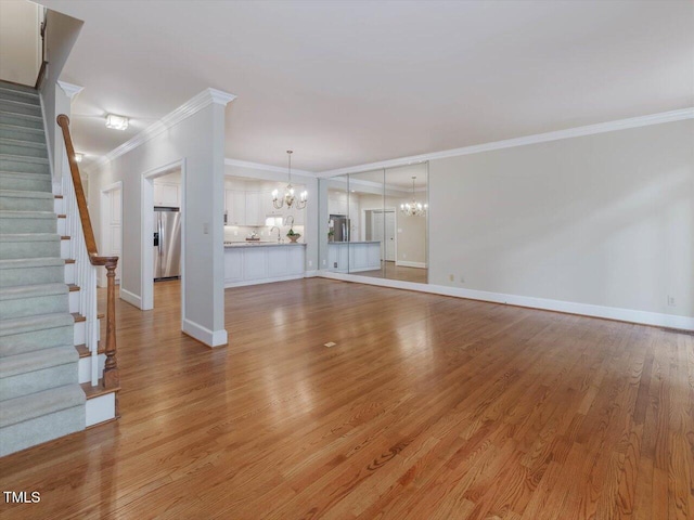 3347 Ridgecrest Ct, Raleigh, NC 27607 - unfurnished living room featuring a chandelier, ornamental molding, baseboards, and light wood finished floors