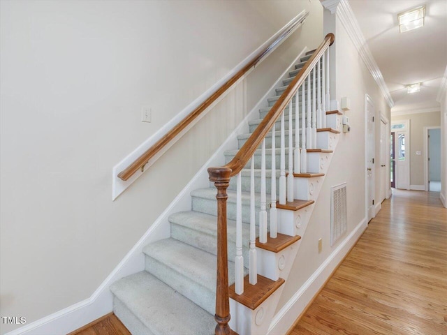3347 Ridgecrest Ct, Raleigh, NC 27607 - stairway with ornamental molding, wood finished floors, and baseboards