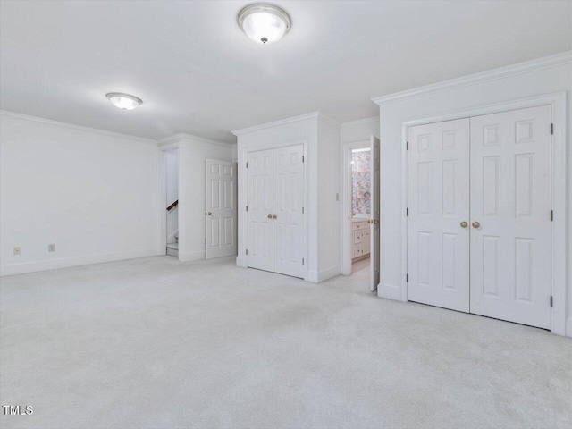 3347 Ridgecrest Ct, Raleigh, NC 27607 - unfurnished bedroom with carpet floors, two closets, crown molding, baseboards, and ensuite bath