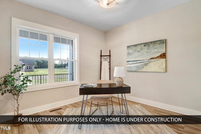 office space featuring baseboards and wood finished floors