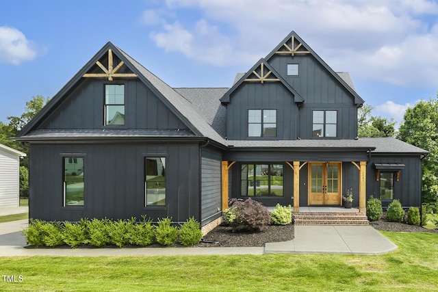 1141 Duke Farm Dr, Wake Forest, NC 27587 - view of front of house featuring board and batten siding, a front lawn, french doors, and a porch