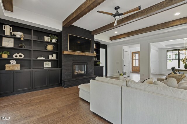 1141 Duke Farm Dr, Wake Forest, NC 27587 - living room with wood finished floors, a brick fireplace, ceiling fan, beamed ceiling, and recessed lighting