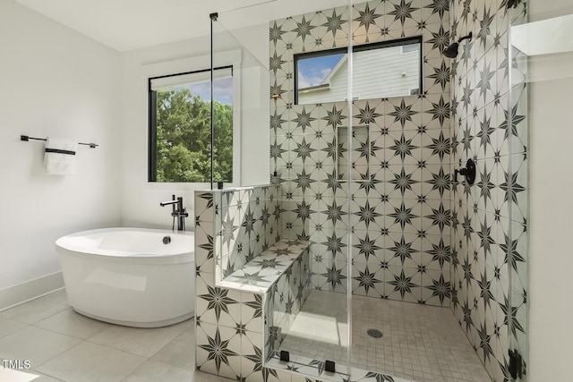 1141 Duke Farm Dr, Wake Forest, NC 27587 - bathroom featuring a freestanding tub, tiled shower, tile patterned floors, and baseboards
