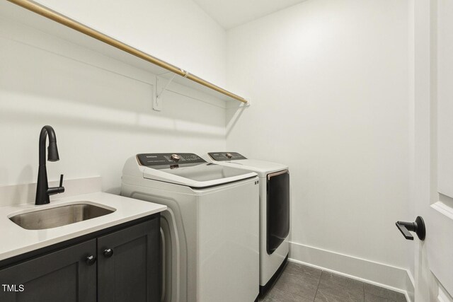 1141 Duke Farm Dr, Wake Forest, NC 27587 - laundry room with cabinet space, washing machine and dryer, dark tile patterned flooring, and baseboards
