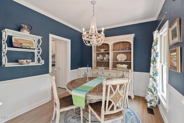19 Knightsbridge Ct, Durham, NC 27707 - dining space with a chandelier, a wainscoted wall, wood finished floors, and ornamental molding