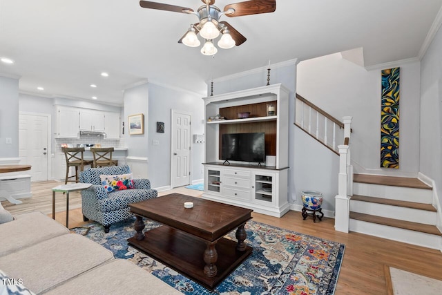 19 Knightsbridge Ct, Durham, NC 27707 - living area featuring a ceiling fan, stairway, crown molding, light wood-type flooring, and baseboards