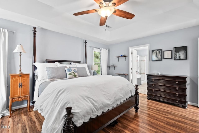 19 Knightsbridge Ct, Durham, NC 27707 - bedroom with a raised ceiling, wood finished floors, baseboards, a ceiling fan, and connected bathroom