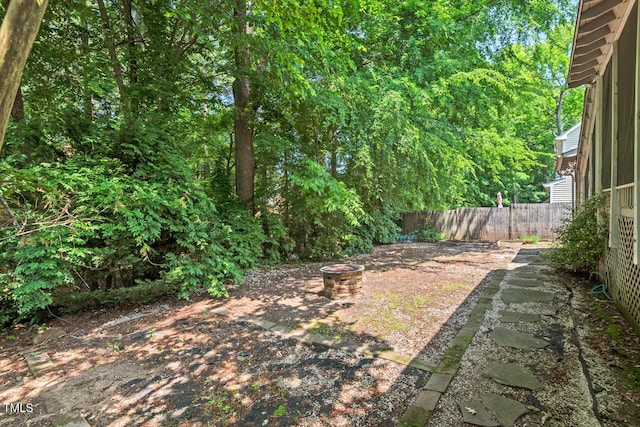 19 Knightsbridge Ct, Durham, NC 27707 - fenced backyard featuring an outdoor fire pit