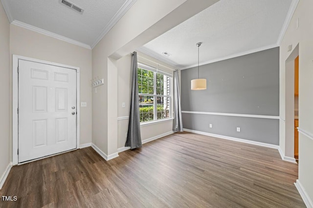 1003 Crimson Dr, Durham, NC 27713 - entrance foyer featuring wood finished floors, crown molding, baseboards, and a textured ceiling