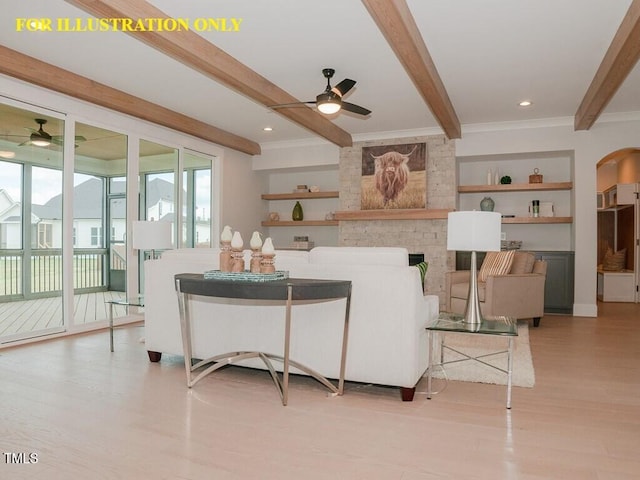 living area featuring a ceiling fan, beamed ceiling, light wood-style floors, healthy amount of natural light, and ornamental molding