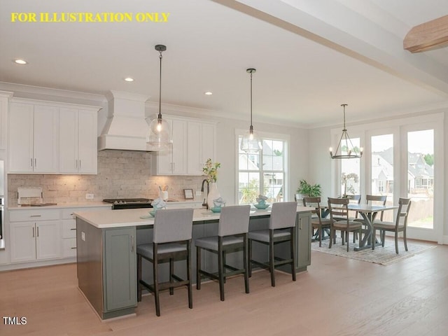kitchen with custom exhaust hood, tasteful backsplash, white cabinetry, light countertops, and crown molding