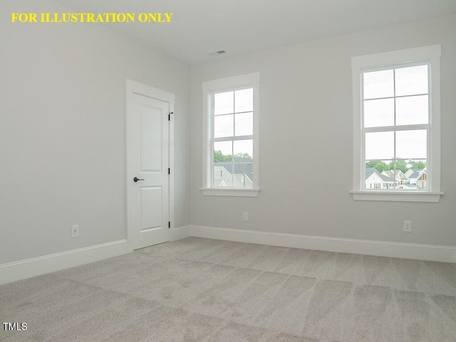 empty room featuring carpet floors, healthy amount of natural light, and baseboards