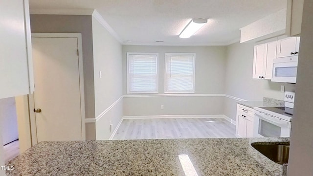 1227 Seaton Rd Unit 60, Durham, NC 27713 - kitchen with white appliances, ornamental molding, light stone countertops, wood finished floors, and white cabinets