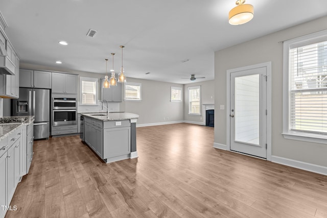 6624 Vestal St, Wake Forest, NC 27587 - kitchen featuring gray cabinets, a sink, stainless steel appliances, a ceiling fan, and open floor plan