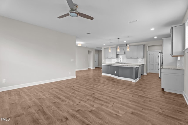 6624 Vestal St, Wake Forest, NC 27587 - unfurnished living room with a sink, recessed lighting, ceiling fan, wood finished floors, and baseboards
