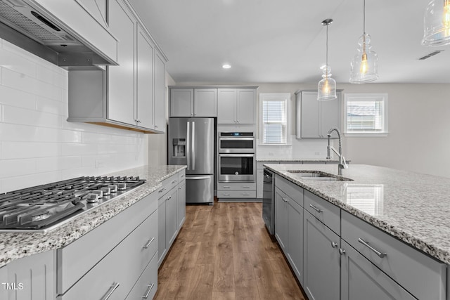 6624 Vestal St, Wake Forest, NC 27587 - kitchen with appliances with stainless steel finishes, a sink, premium range hood, gray cabinetry, and recessed lighting