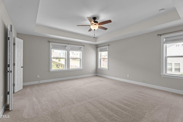 6624 Vestal St, Wake Forest, NC 27587 - empty room featuring a tray ceiling, a ceiling fan, light colored carpet, and baseboards