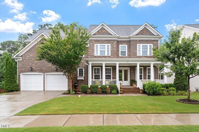 213 Preatonwood Dr, Apex, NC 27539 - view of front of house with brick siding, concrete driveway, covered porch, and a front lawn