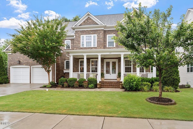 213 Preatonwood Dr, Apex, NC 27539 - view of front of house with a porch, brick siding, driveway, a front yard, and an attached garage