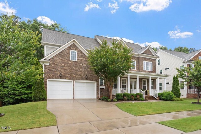 213 Preatonwood Dr, Apex, NC 27539 - view of front of home featuring brick siding, covered porch, driveway, a front yard, and a garage