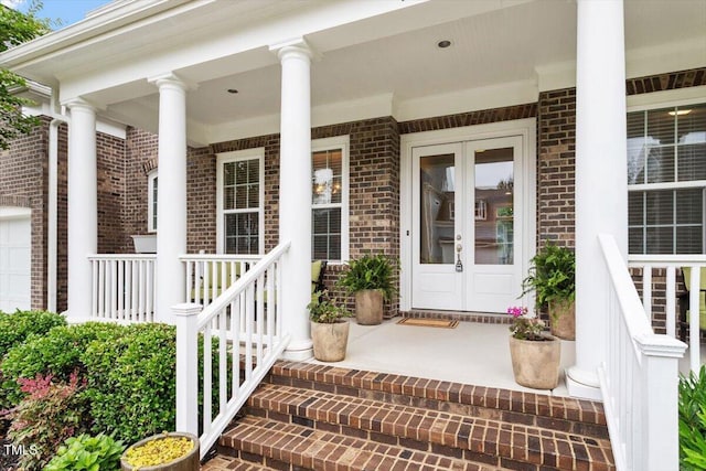 213 Preatonwood Dr, Apex, NC 27539 - view of exterior entry featuring brick siding, a porch, and french doors