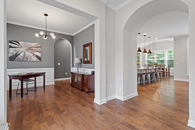 213 Preatonwood Dr, Apex, NC 27539 - hall featuring arched walkways, dark wood-type flooring, baseboards, a chandelier, and ornamental molding