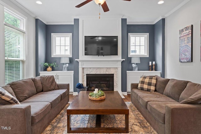 213 Preatonwood Dr, Apex, NC 27539 - living area with wood finished floors, a ceiling fan, a high end fireplace, recessed lighting, and crown molding