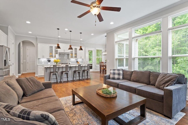 213 Preatonwood Dr, Apex, NC 27539 - living area featuring a ceiling fan, arched walkways, light wood-type flooring, recessed lighting, and ornamental molding